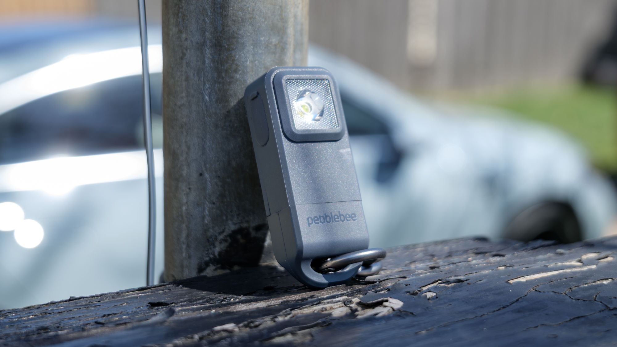 Pebblebee Halo held resting on its side.