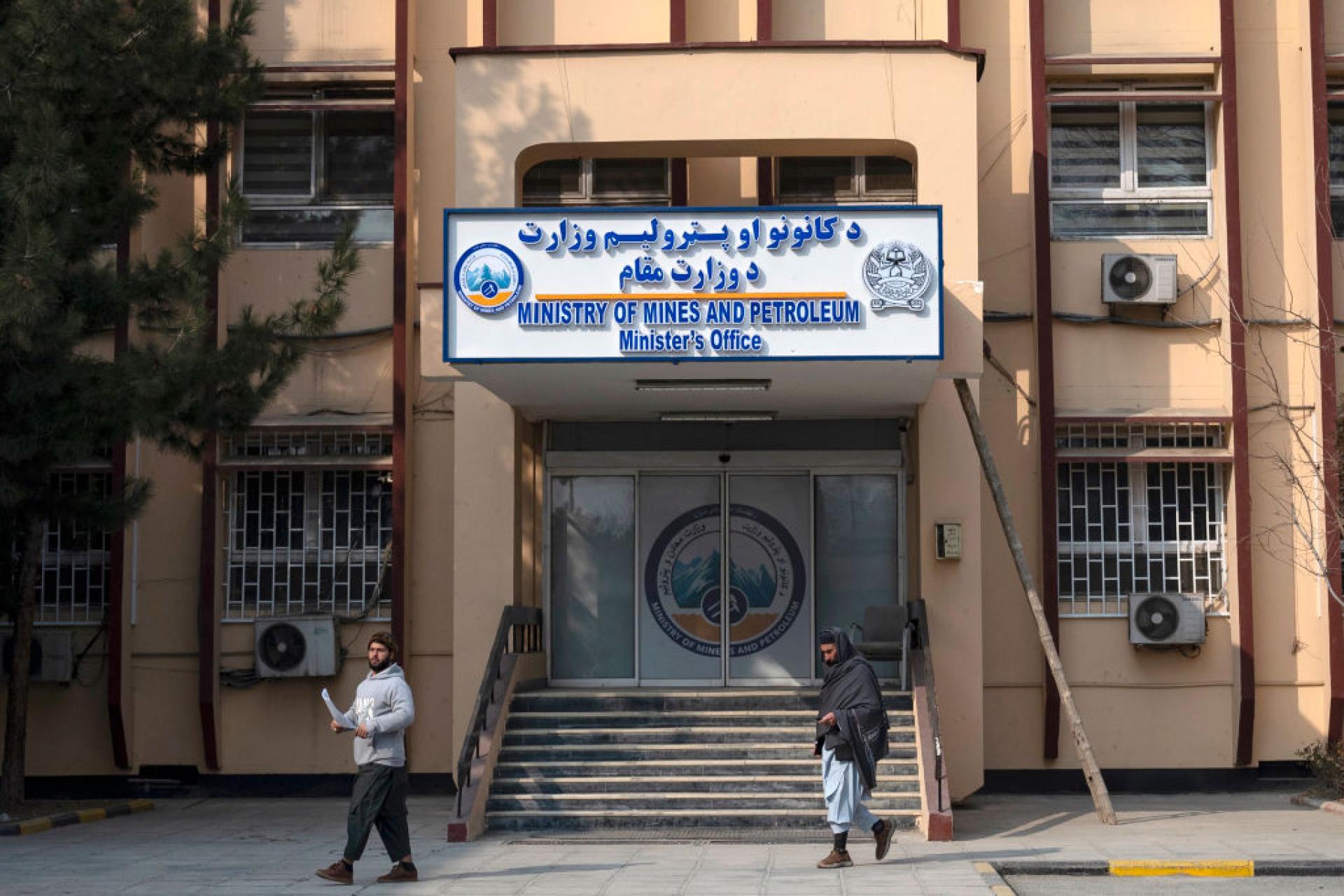 Men walking past the minister's office of the ministry of mines and petroleum, in Kabul (Wakil Kohsar/AFP via Getty Images)