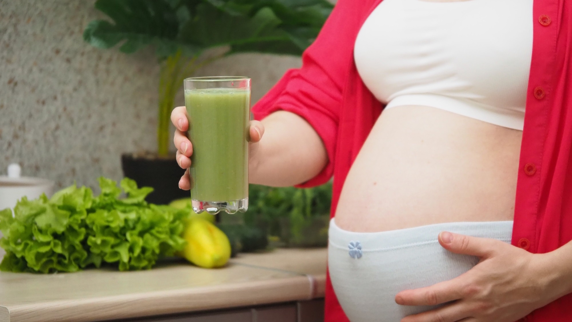 Pregnant Woman drinking green smoothie
