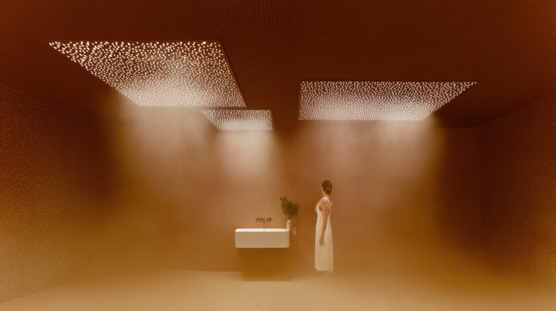 A person in a white dress stands in a minimalist, steam-filled room with a sink and perforated ceiling panels emitting light.