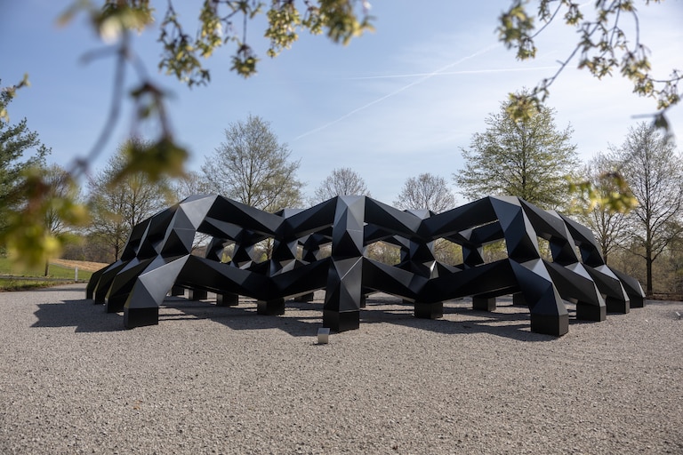 THURSDAY, APRIL 9, 2026 - "Smug," an aluminum outdoor sculpture by Tony Smith in 1973, was an uncompleted work when Smith died in 1980. The Glenstone Museum, in partnership with the artist's estate, helped to complete the work in 2005. Smith's work uses geometric shapes that shift the viewer's perspective depending on where they stand.