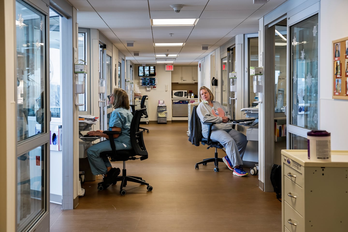 Nurses worked at computer stations inside the neonatal intensive care unit at Mount Auburn Hospital in Cambridge. The hospital integrates midwives and obstetricians in its maternity care model, emphasizing patient-centered care and maintaining one of the lowest Cesarean section rates in the state.