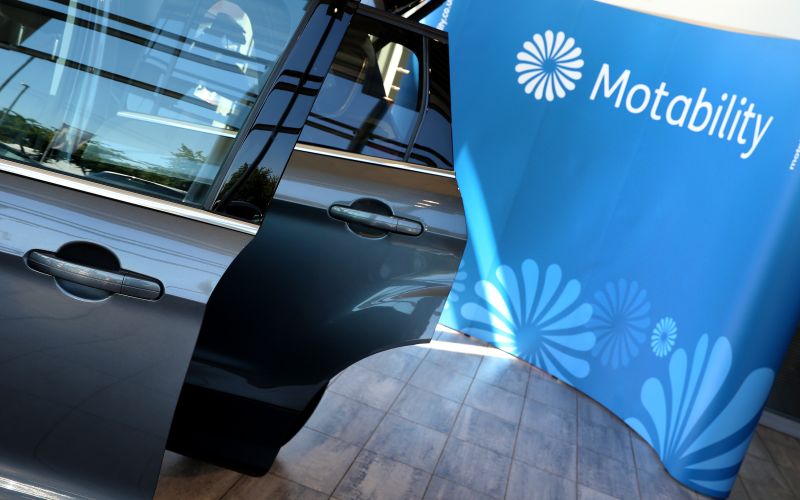 Motability logo beside an open car door