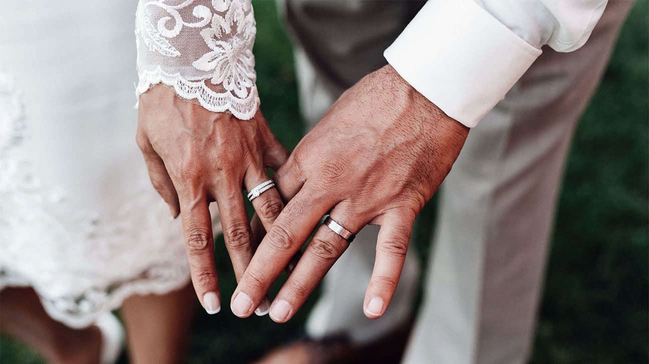 Close-up of a couples hands with wedding rings on/wedding day