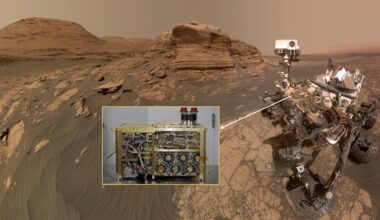 a photograph of a four-wheeled robot on a reddish-orange dusty surface