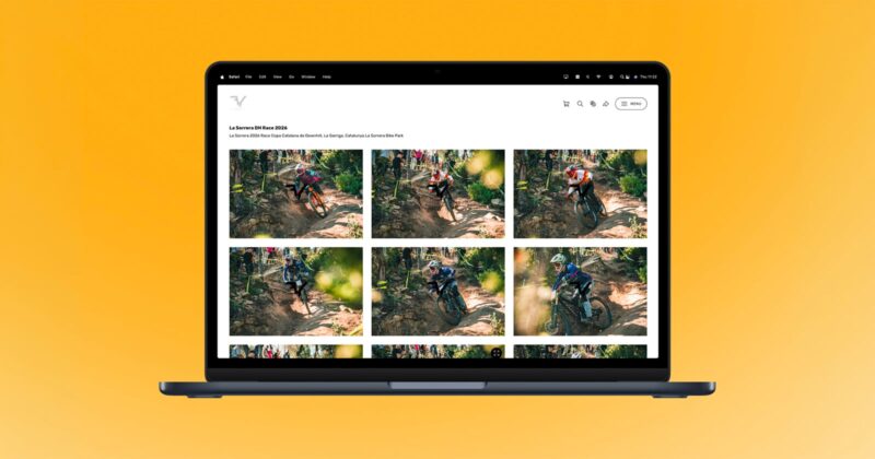 A laptop displays a photo gallery of mountain bikers riding on a rugged forest trail, set against a bright orange background.