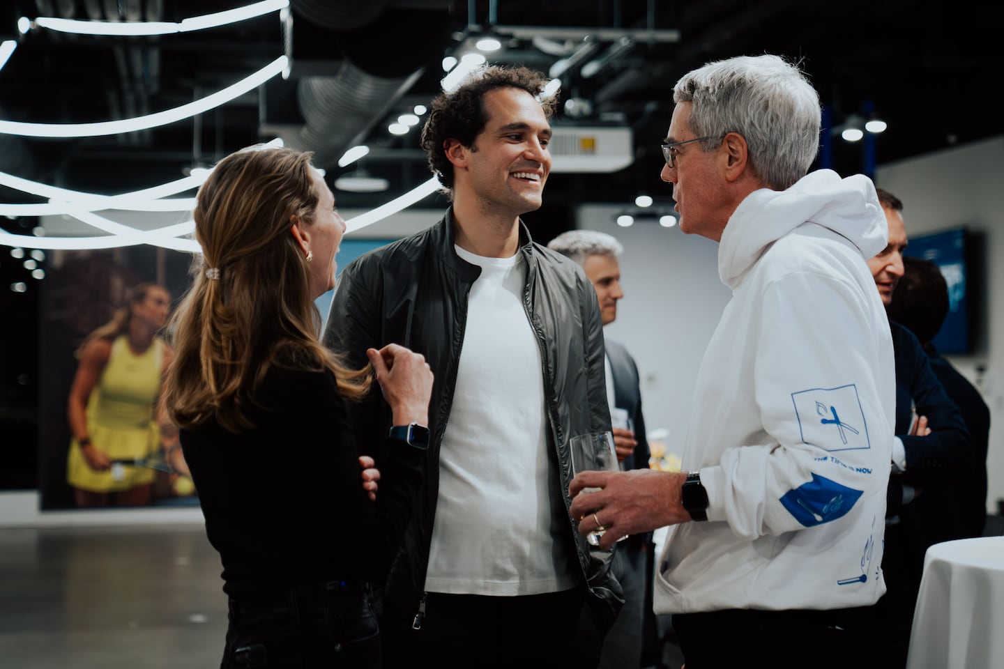 Whoop chief executive Will Ahmed (center) recently hosted local tech executives at his firm's Fenway headquarters to discuss how to encourage more startups working on AI apps to come to Boston.