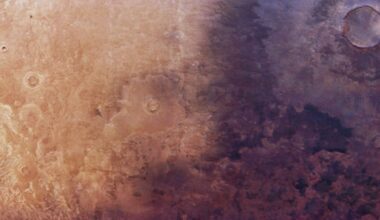 Aerial photo of Mars showing a dark shadow-like patch of ground