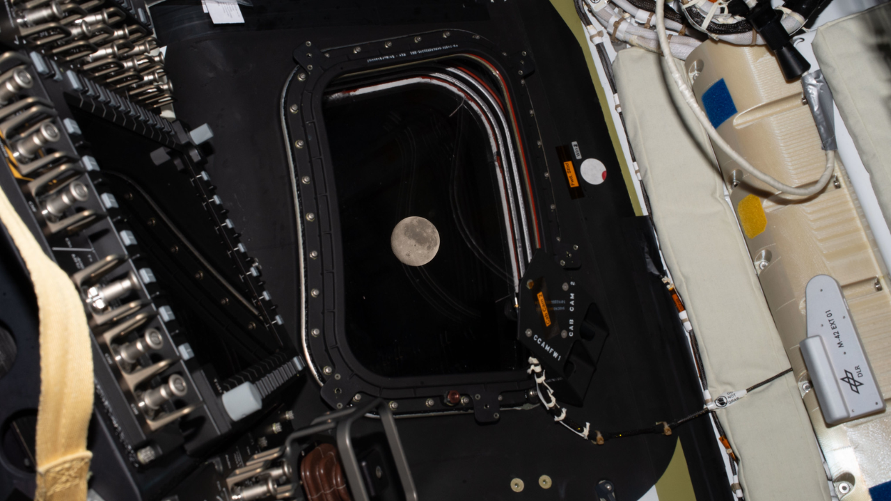 The moon is seen through a window on the Artemis 2 spacecraft on Flight Day 5 of Artemis 2