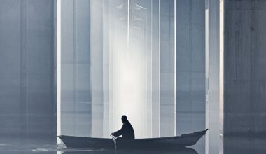 A person rows a small boat through calm waters under a modern bridge, with towering concrete beams