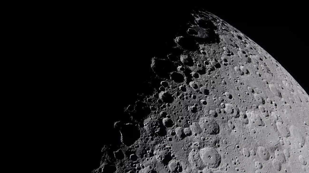 The moon's face divided sharply between light and shadow.