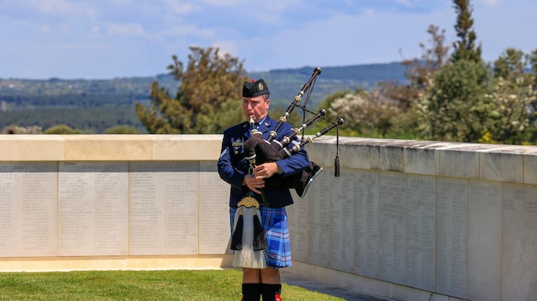 A British soldier plays a pipe.