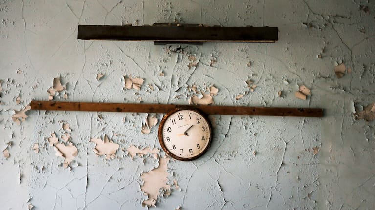 A broken clock hangs on a wall in a school in the deserted town of Pripyat, Ukraine, April 5, 2017.