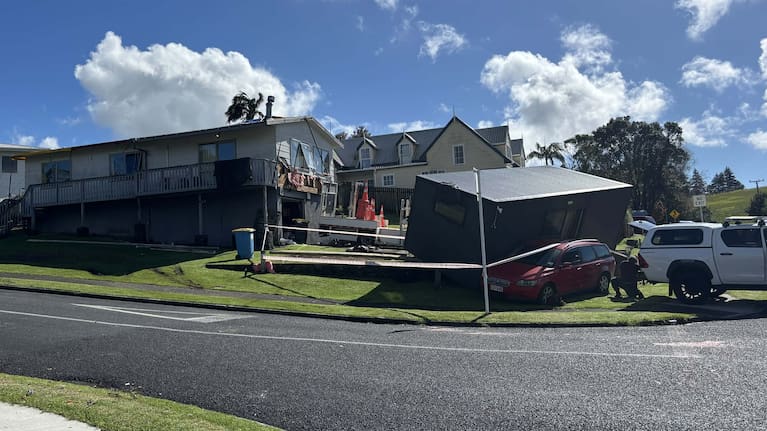 A cabin blown onto a car in Tauranga's Welcome Bay.