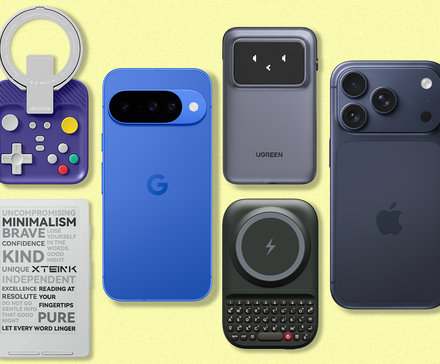 A collection of smartphones and accessories including a gaming controller, an e-reader, a portable battery, and a clip-on keyboard on a pale yellow background.