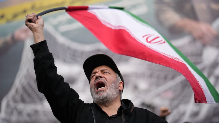 A government supporter chants slogans during a gathering after the announcement of a two-week ceasefire with the United States and Israel in Tehran, Iran.