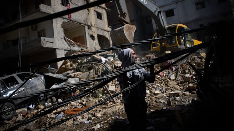 A man works at the site of Sunday's Israeli strike on a building in Beirut's Jnah neighborhood, Lebanon.