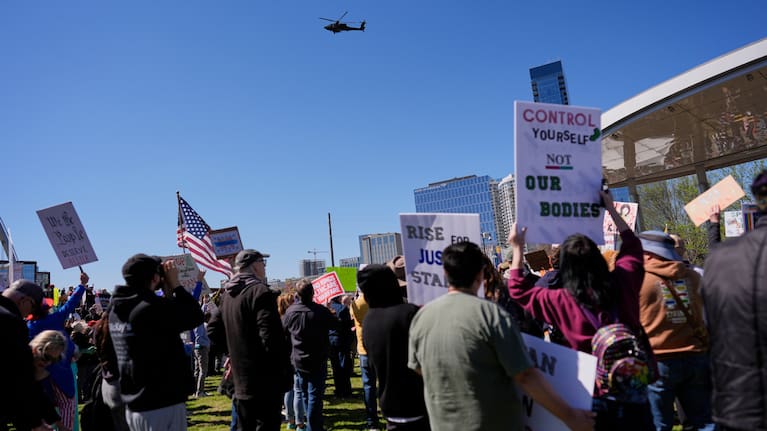 A military helicopter flies over a No Kings protest Saturday, March 28, 2026, in Nashville