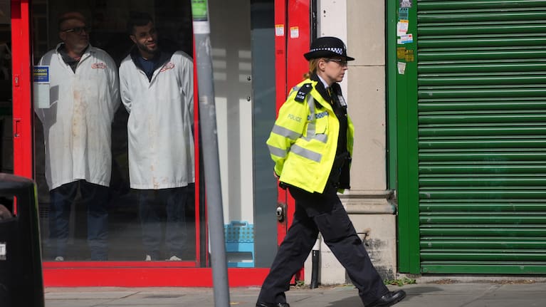 A Police officer patrols the high street after two people were stabbed in Golders Green neighbourhood, that has a large Jewish community, in London.