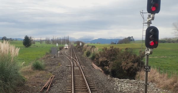Freight train blew past stop signals towards rail truck on tracks