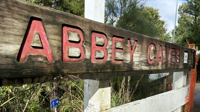 A sign outside Abbey Caves, where a Whangārei student was swept away by flood waters.