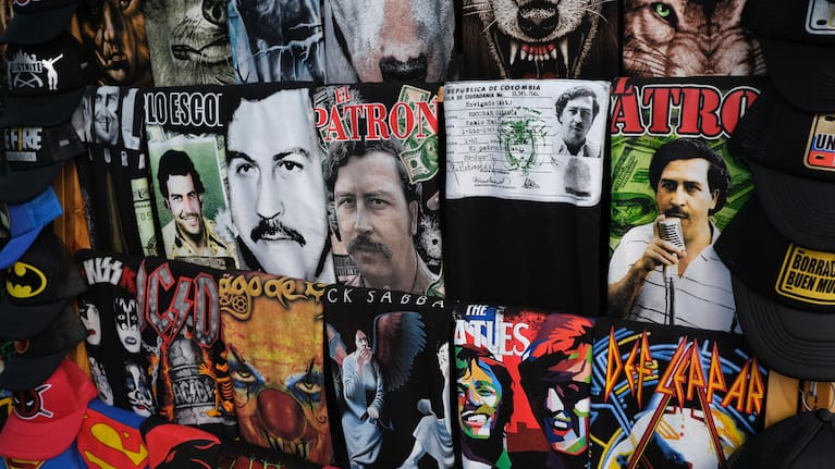A street vendor sells tee shirts with image of Colombian drug lord Pablo Escobar in a market place.