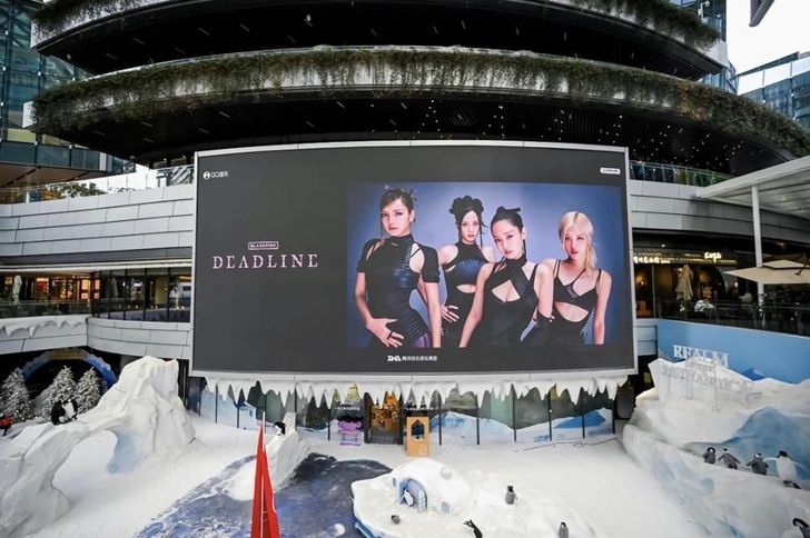 Promotional visuals for K-pop girl group BLACKPINK’s 'DEADLINE' album are displayed on a large outdoor screen in China as part of a multi-city campaign marking the album’s release. The group’s latest five-track album was composed entirely of English-language tracks. Courtesy of YG Entertainment