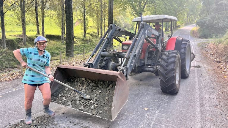 Alex Campbell, manager of Awapapa Station Farm, and his wife, Megan Campbell, fill up the potholes they call "craters" with gravel on the stretch of Tiniroto Rd by their house.