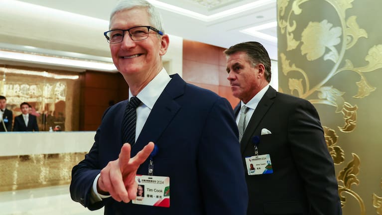 Apple CEO Tim Cook reacts at the annual meeting of the China Development Forum at the Diaoyutai Guesthouse in Beijing, China