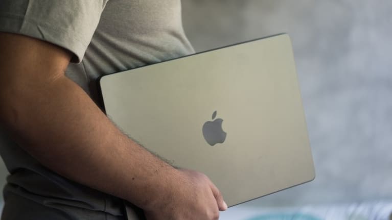 The man got into the back seat with the woman's child and told her to drive to electrical stores and demanded she buy him Apple MacBooks.