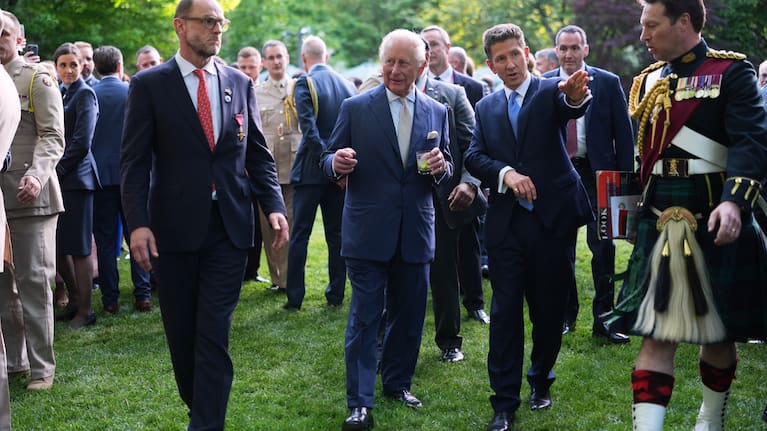 Britain's King Charles III and British Ambassador to the U.S. Christian Turner, right, attend a garden party at the British Embassy.