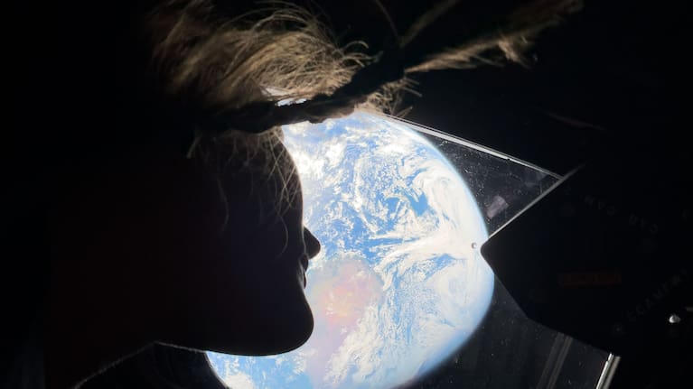 Christina Koch takes a moment to look back at Earth as they continue deep into space toward the Moon.