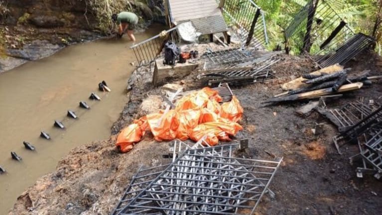 Clean up at the Fairy Falls in the Waitākere Ranges, following a devastating fire on November 2, 2025.