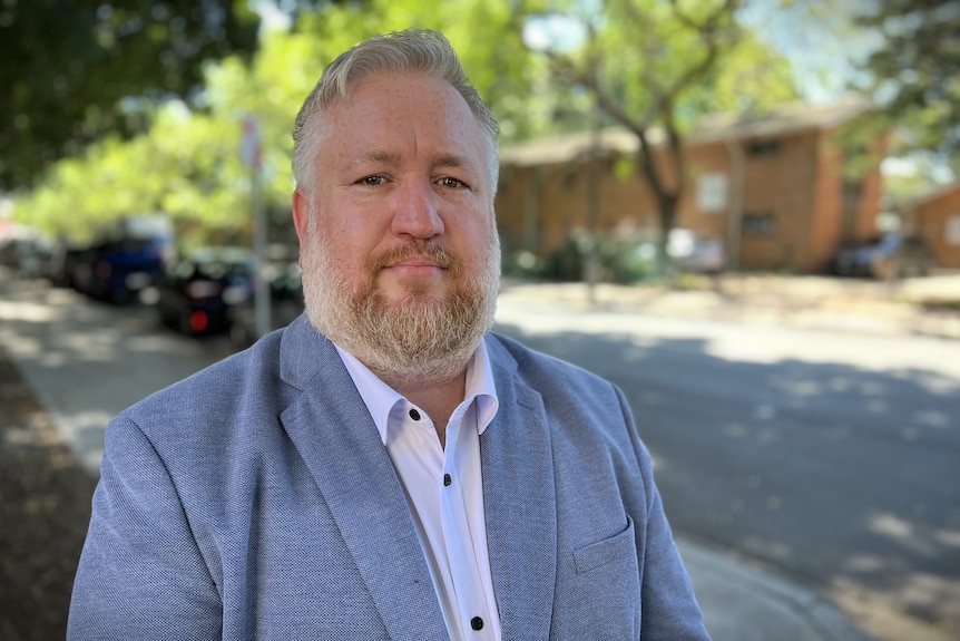 man standing outside looking at camera