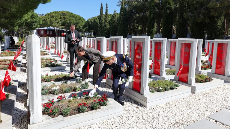 Deputy Commander of the French Strike Force Vice Admiral Yannick Bossu places red carnations at the Turkish Martyrs' cemetery.
