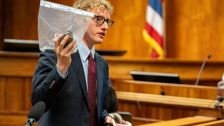 Deputy Prosecutor Joel Garner holds a rock as evidence while presenting closing arguments during the attempted murder trial of Gerhardt Konig in a courtroom, Tuesday, April 7, 2026, in Honolulu. 