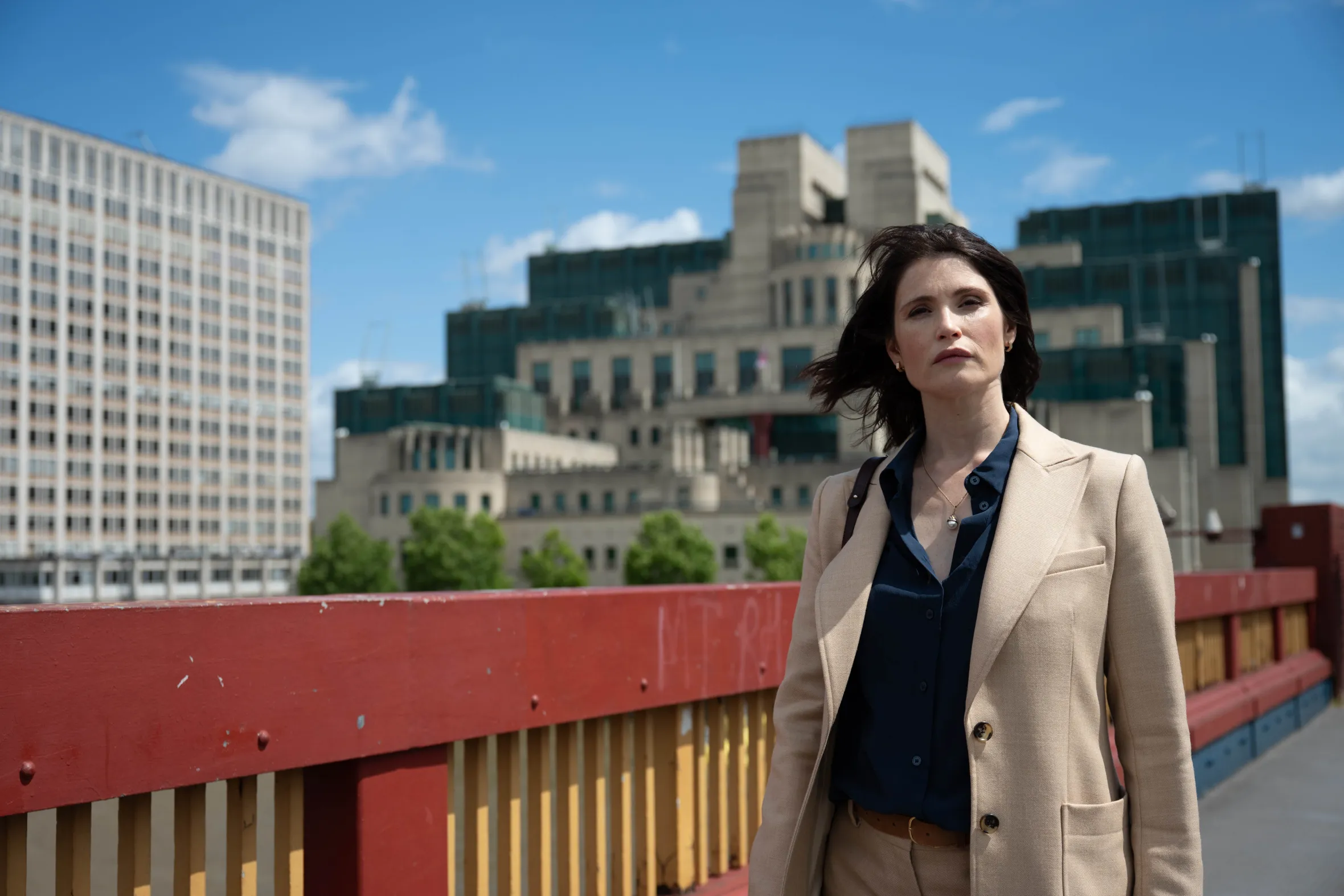 Kate (Gemma Arterton) on a bridge with buildings in the background.