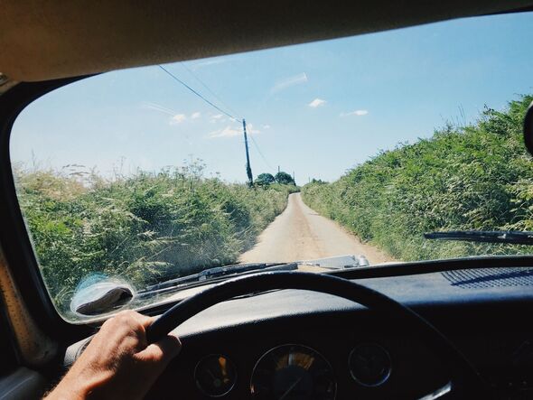 Driver view inside car of country road Driver view inside car of country road