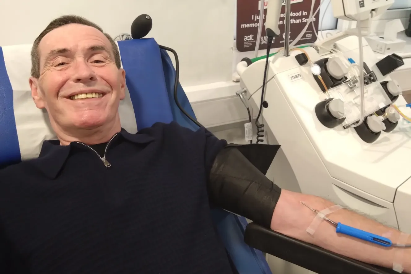 David Smith, 64, smiling while donating blood for an intrauterine transfusion to save the life of Arthur Ransom.
