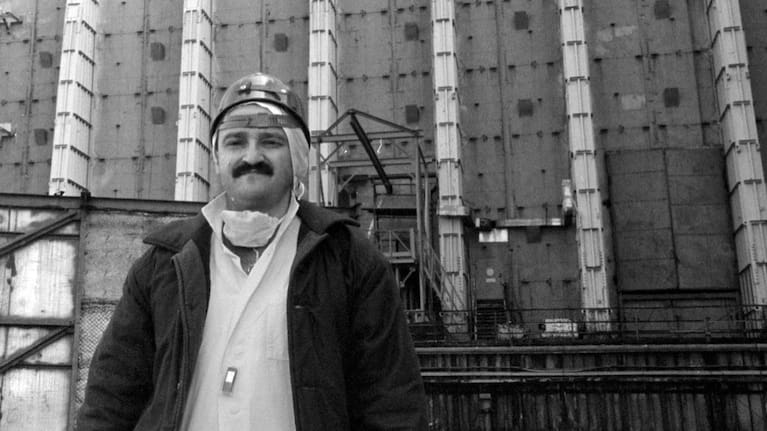 Efrem Lukatsky, now an Associated Press photographer, wears protective clothes outside the sarcophagus that covers destroyed Reactor No. 4 in the Chernobyl nuclear power plant in Chernobyl, Ukraine.