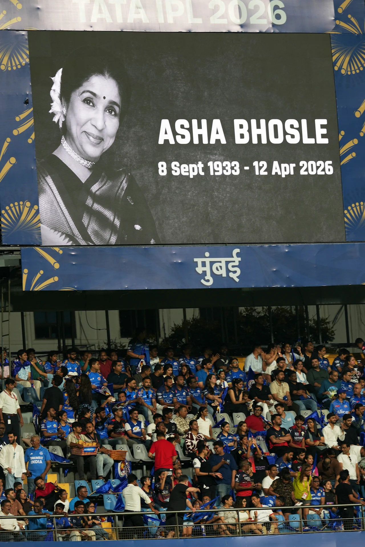 A tribute to legendary Indian singer Asha Bhosle reflects on the giant screen during the Indian Premier League cricket match between Mumbai Indians and Royal Challengers Bengaluru, in Mumbai, India, Sunday, April 12, 2026. (AP Photo/Rafiq Maqbool)