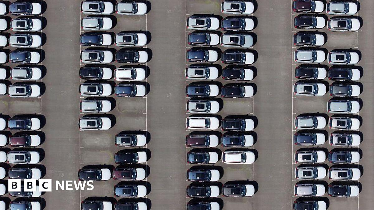An aerial view of whit and black imported new cars on the quayside of Alexandra Dock at Grimsby Port.