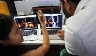 Employees discuss a character from the AI-generated series "Mahabharat" seen on a laptop screen at Galleri5, the tech studio arm of Collective Artists Network, at its office in Bengaluru, India, November 26, 2025.