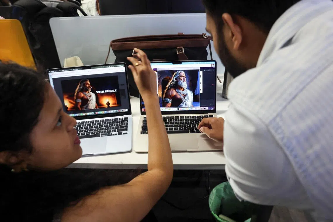 Employees discuss a character from the AI-generated series "Mahabharat" seen on a laptop screen at Galleri5, the tech studio arm of Collective Artists Network, at its office in Bengaluru, India, November 26, 2025.