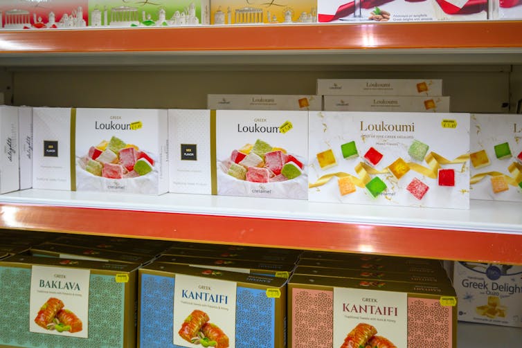 boxes of greek sweets on a supermarket shelf