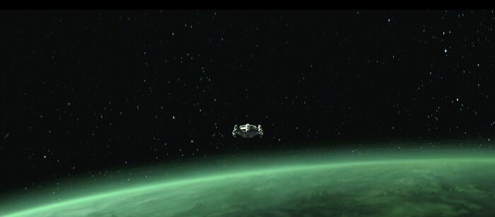 Spacecraft orbiting a green planet in a star-filled outer space setting from Star Wars Maul Shadow Lord series. Spacecraft orbiting a green planet in a star-filled outer space setting from Star Wars Maul Shadow Lord series.
