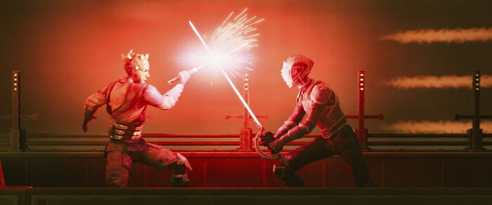 Star Wars Maul Shadow Lord lightsaber duel scene with two characters fighting in a dark red setting. Star Wars Maul Shadow Lord lightsaber duel scene with two characters fighting in a dark red setting.