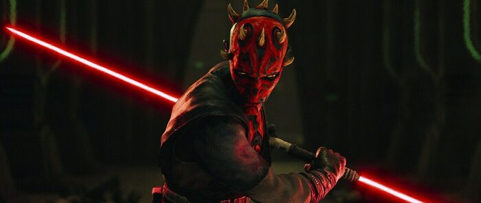 Darth Maul wielding a red double-bladed lightsaber in a dark setting for Star Wars Maul Shadow Lord release. Darth Maul wielding a red double-bladed lightsaber in a dark setting for Star Wars Maul Shadow Lord release.