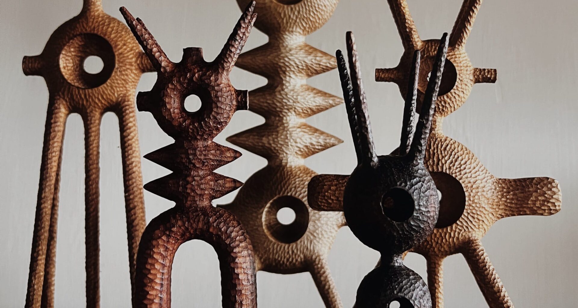 a collection of small, abstract, spindly wooden sculptures