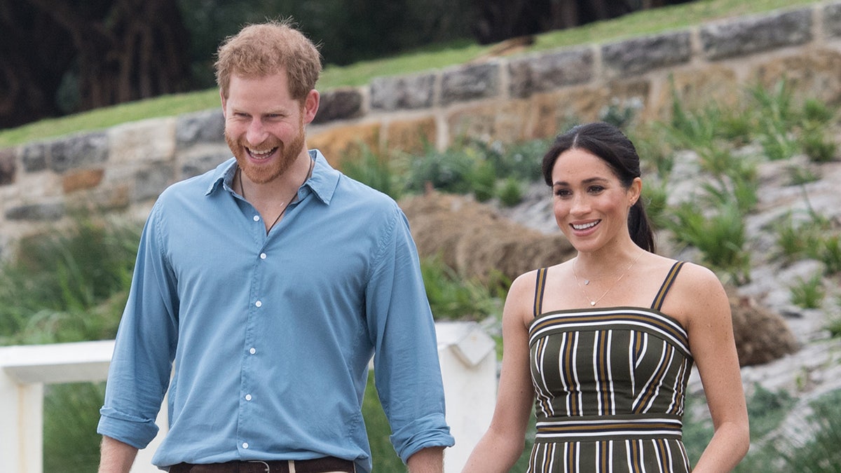 Prince Harry and Meghan Markle standing together at Bondi Beach in Sydney